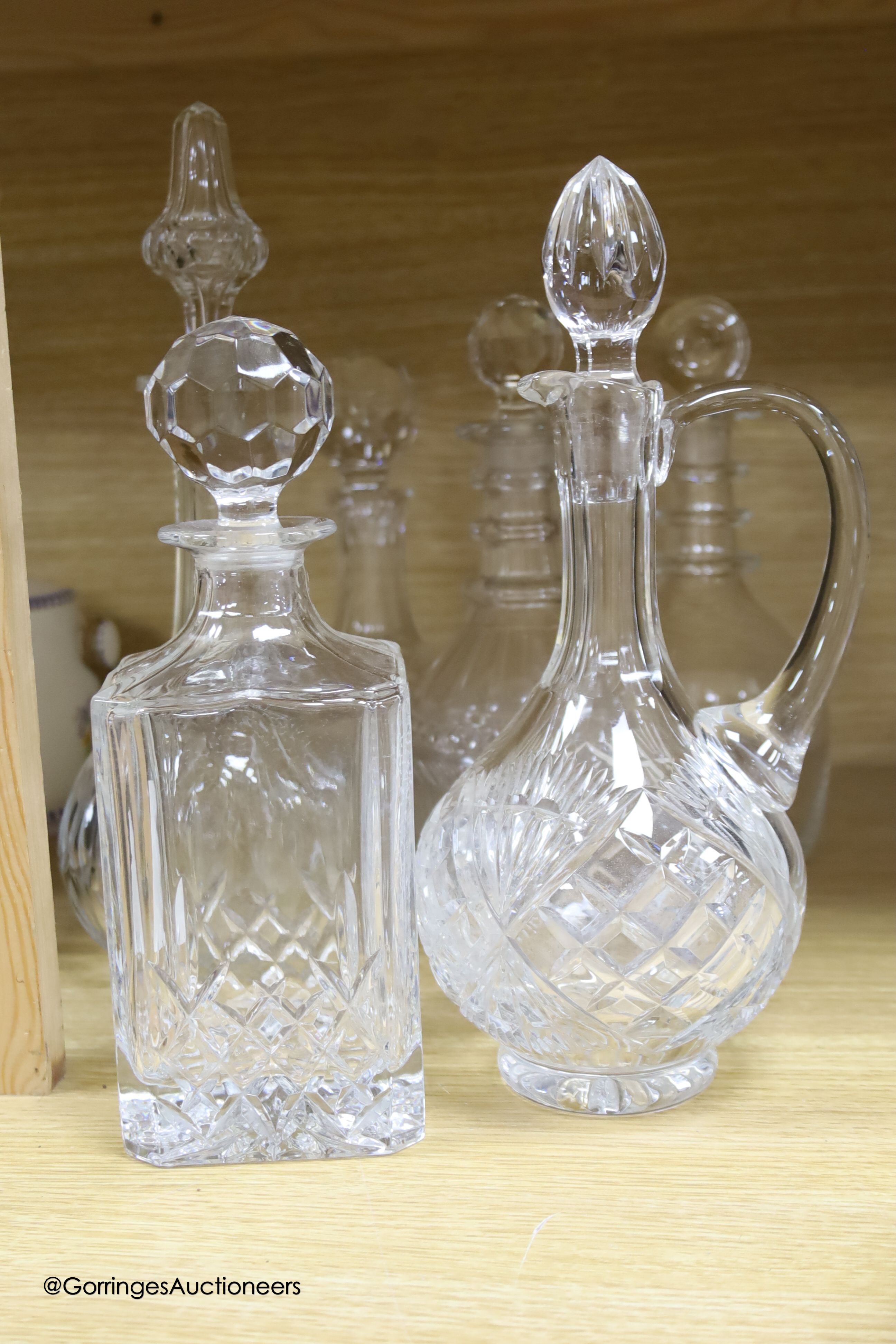 A collection of clear cut glass decanters